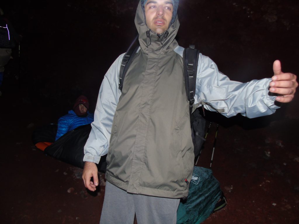 I am standing tired near the summit of Mt. Fuji. Climbing Mt. Fuji at night.