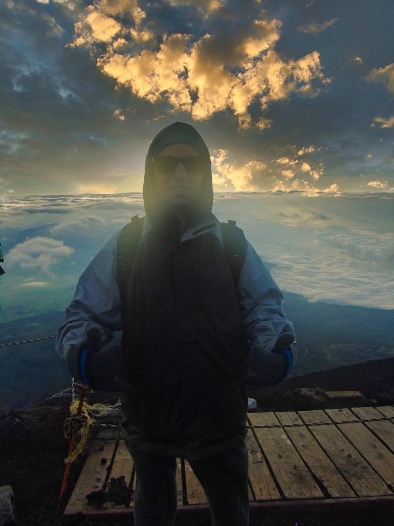 Smiling at the summit of Mt. Fuji just before Sunrise.