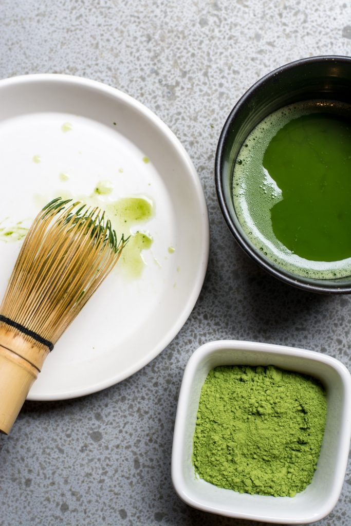 Matcha powder and a cup of matcha.