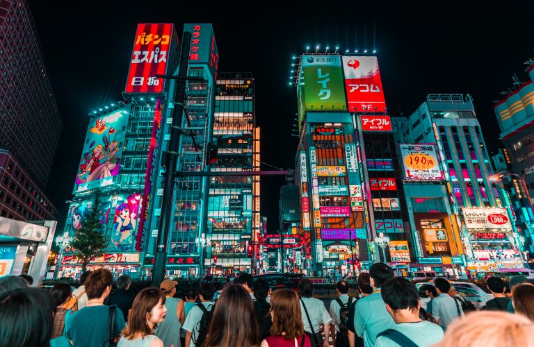 Shinjuku at night with bright neon lights.