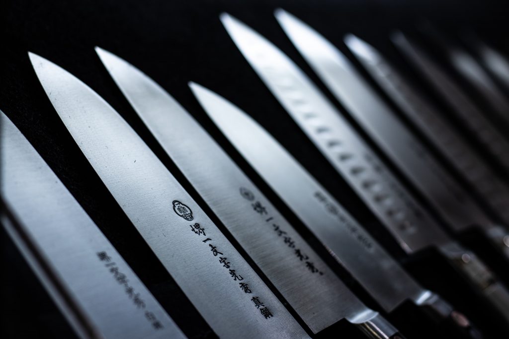 Japanese knives on display with Japanese inscriptions. 