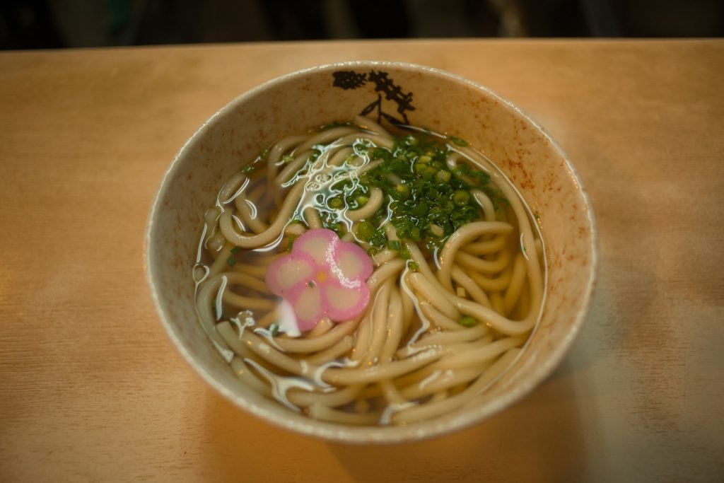 Japanese Udon in a bowl with pink fish paste.