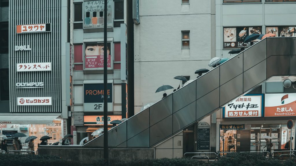 People on the way back from work in Tokyo while is raining during Japan's rainy season.