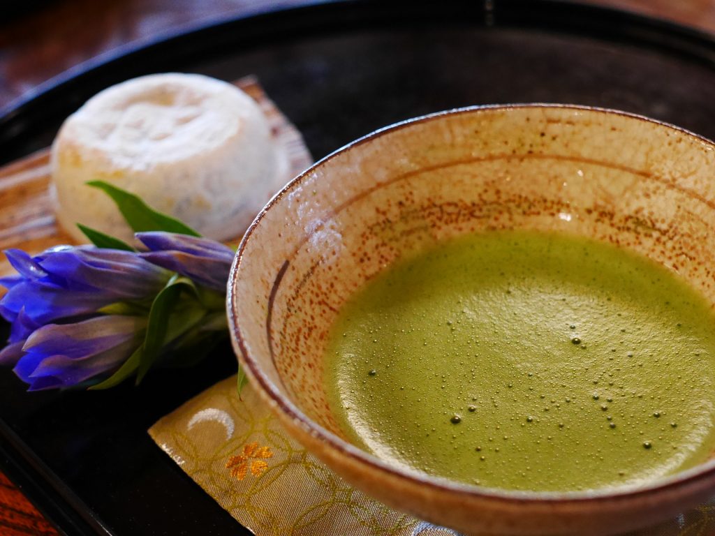 My 12 Favorite Japanese Experiences tea making ceremony a cup of green tea served with Japanese sweet
