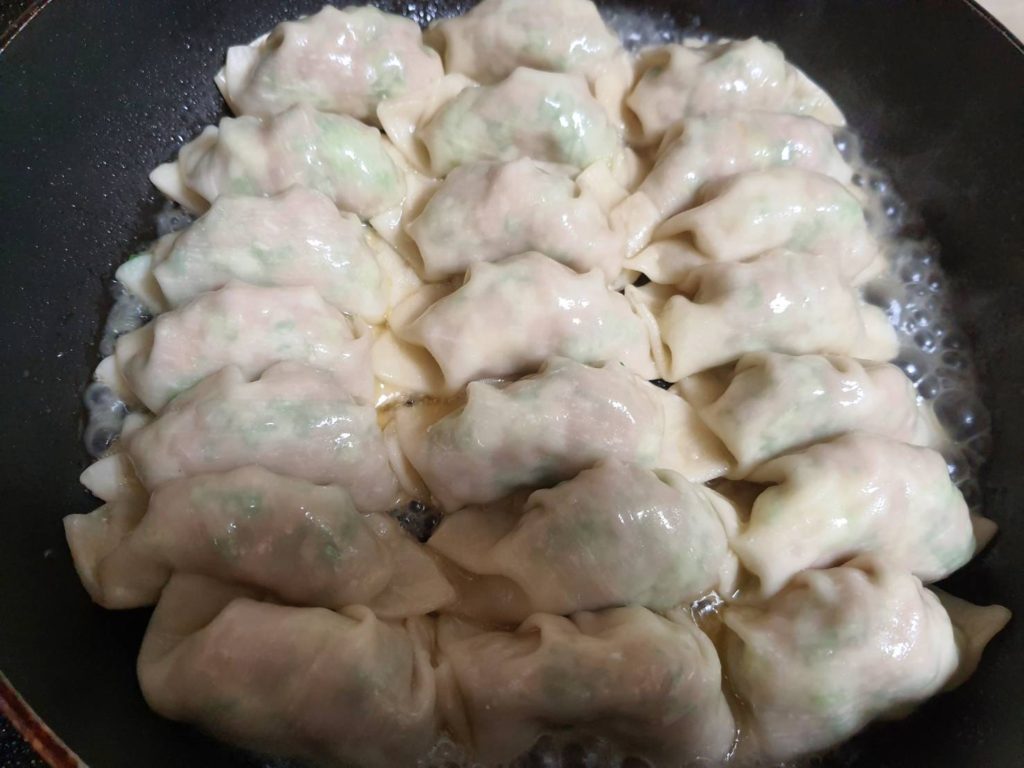 The Gyoza cooking on the frying pan