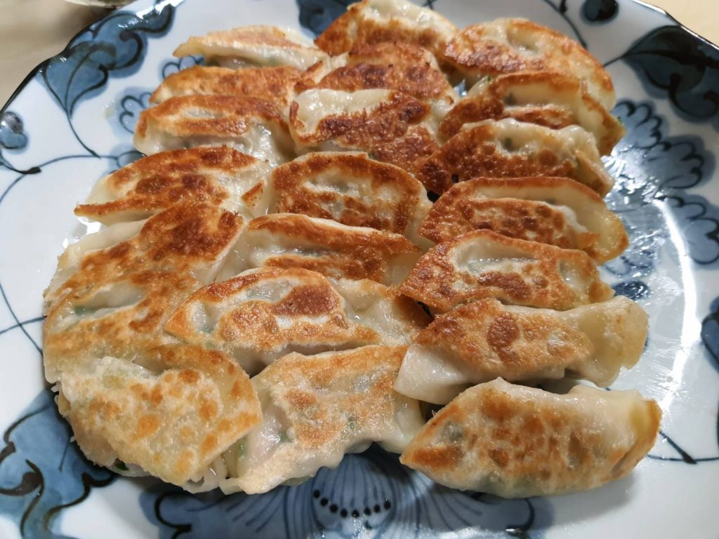 Golden Gyoza being served on a plate.
