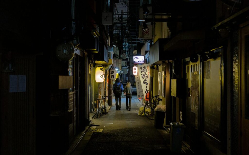 Couple travelling in Japan using a phone for directions