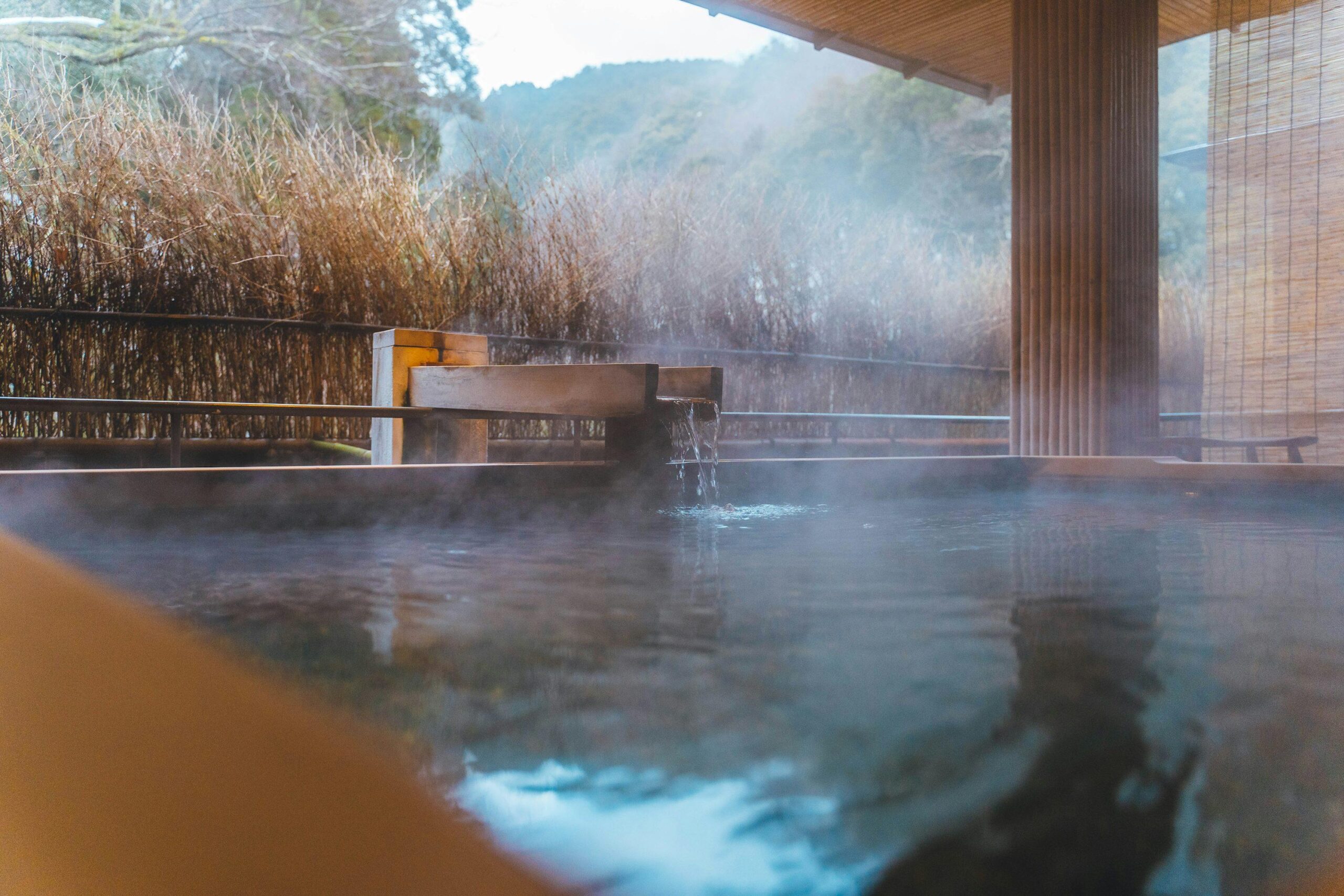 Japanese outdoor hot spring with mountain scenery
