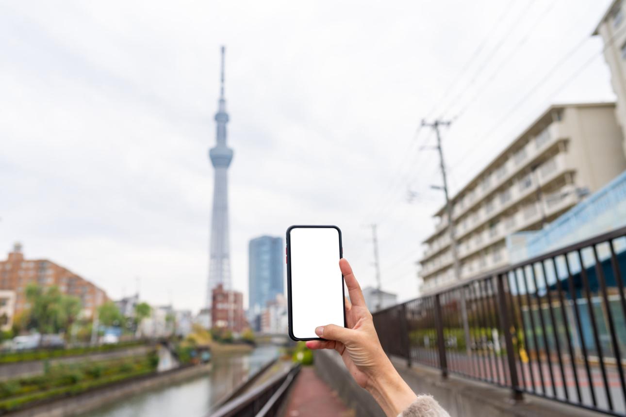 Traveller using a phone in Tokyo, Japan